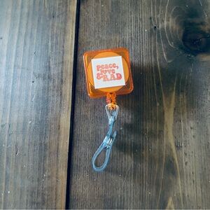 Peace Love Rad orange badge reel